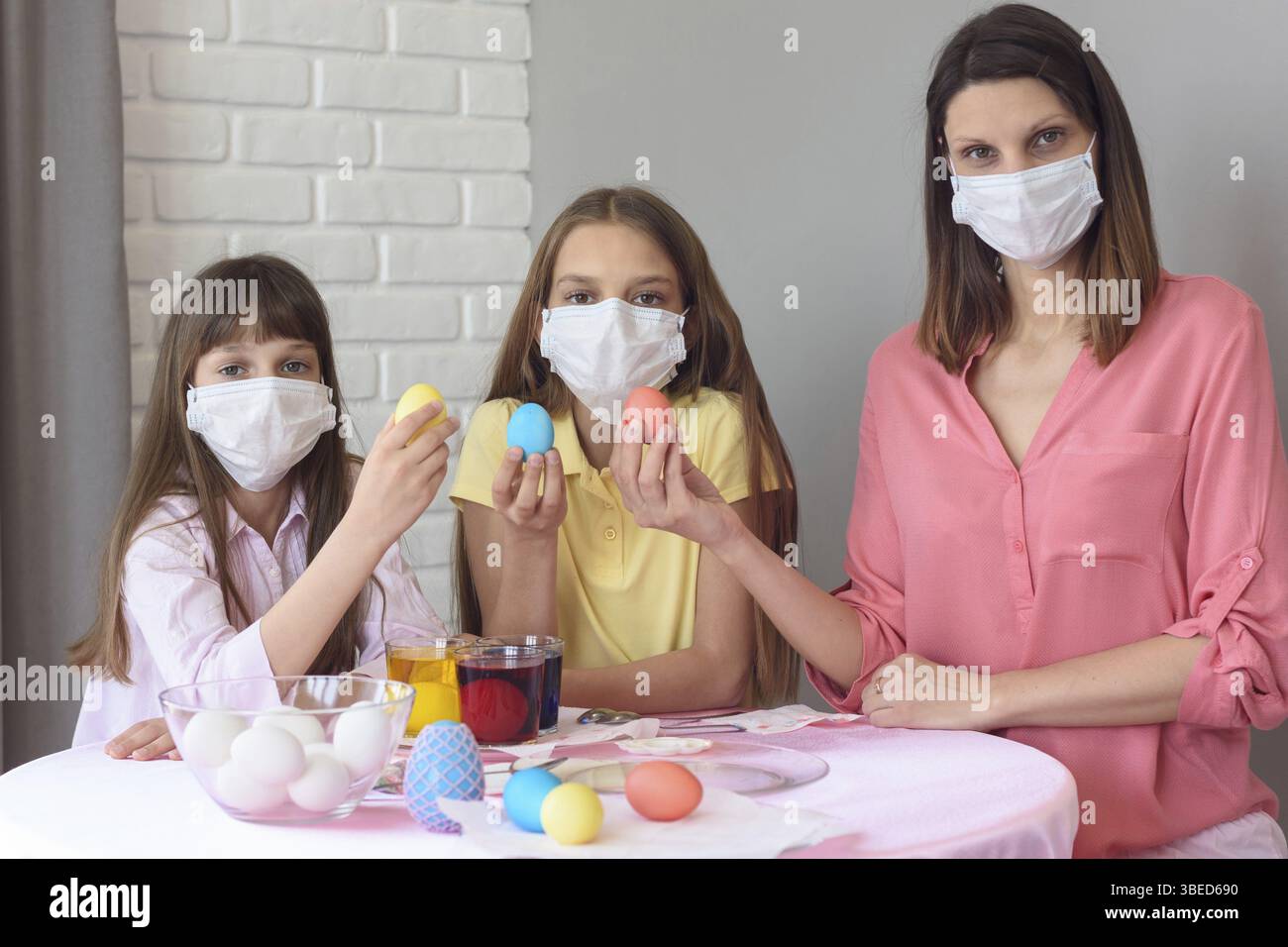 Quarantined family paints eggs for easter Stock Photo