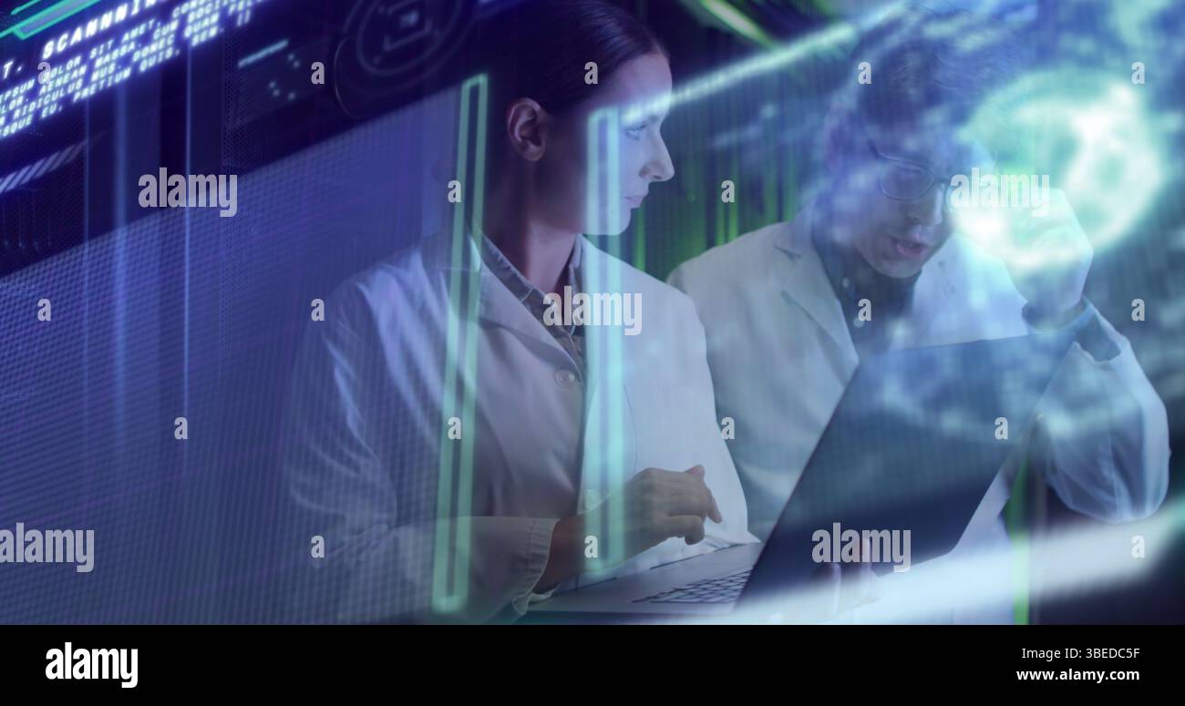 Data processing against diverse male and female engineers using laptop at computer server room Stock Photo