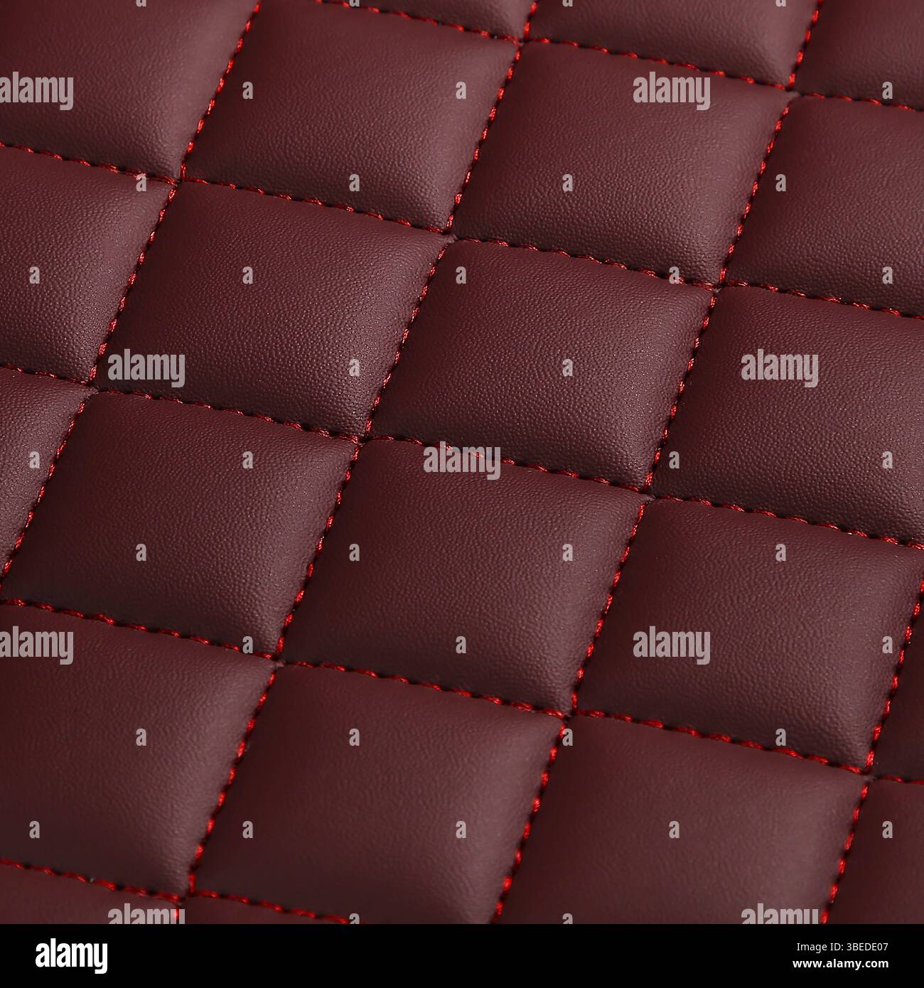 Texture of red leather background with square pattern and stitch, macro Stock Photo