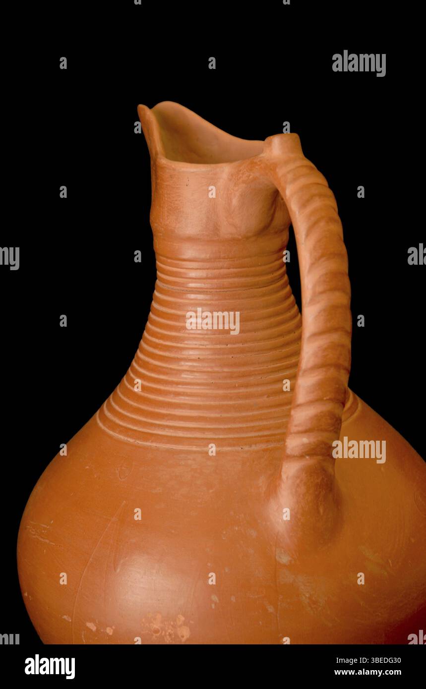 A brown clay jug isolated on a black background Stock Photo