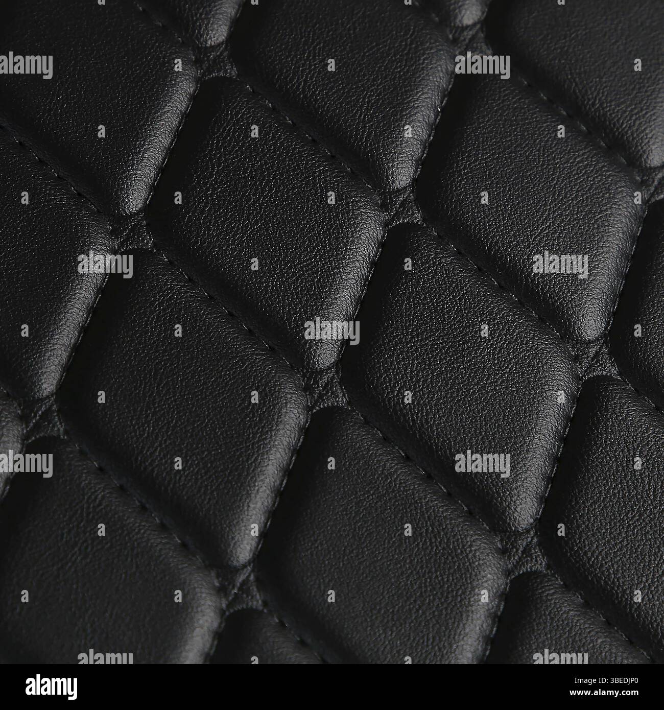 Texture of black leather background with square pattern and stitch, macro Stock Photo