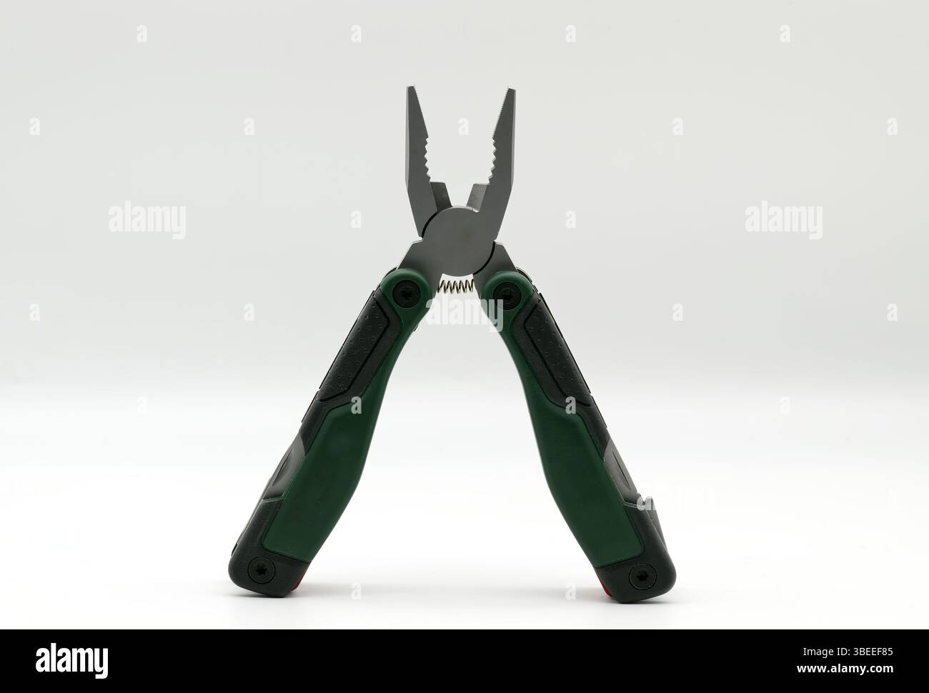 Multi tool with multiple functions and pliers on white background. Stock Photo