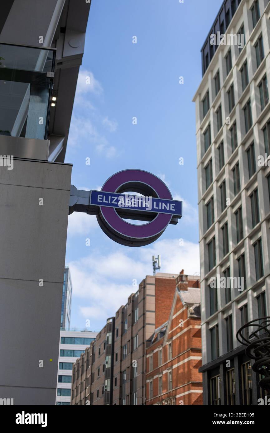 A sign for the Elizabeth Line in London is displayed amidst modern ...