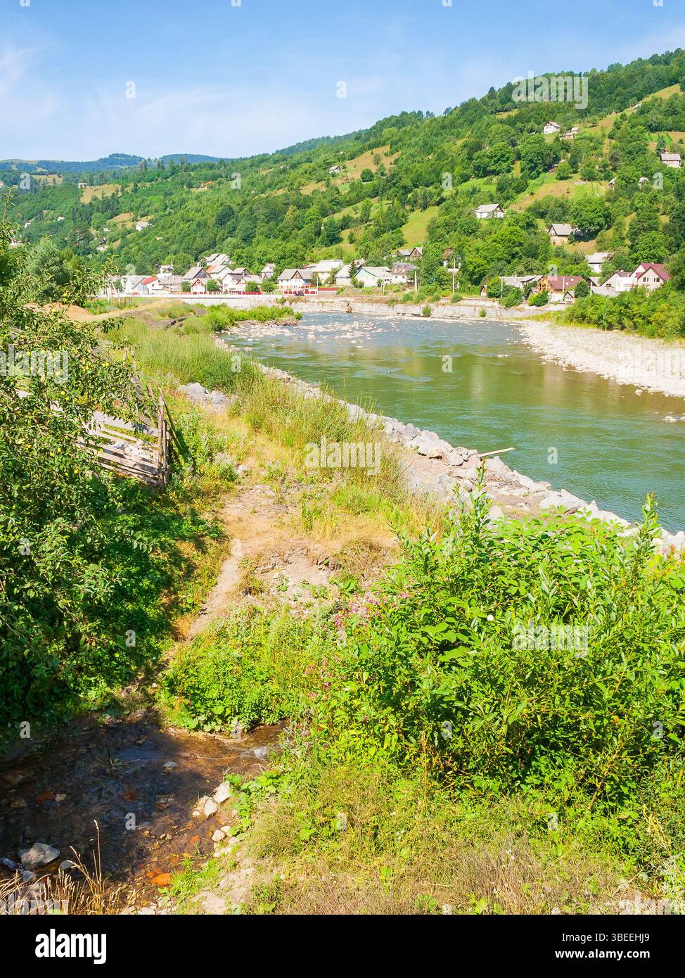 tisza river running through the valley. winding water flow. sunny weather in summer. mountainous countryside landscape of rakhiv region in ukraine. ru Stock Photo
