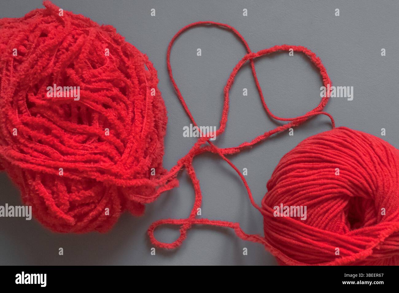 Two red threads in the shape of a heart. Red yarn. Heart shape. Red and ...