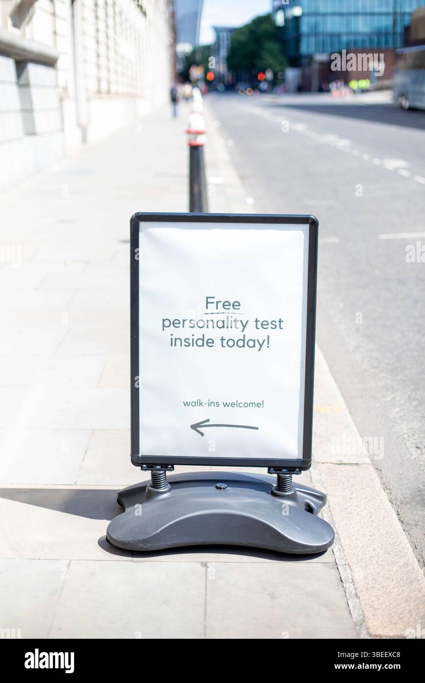 A sign offering a free personality test on a street in London, welcoming walk-ins. Stock Photo