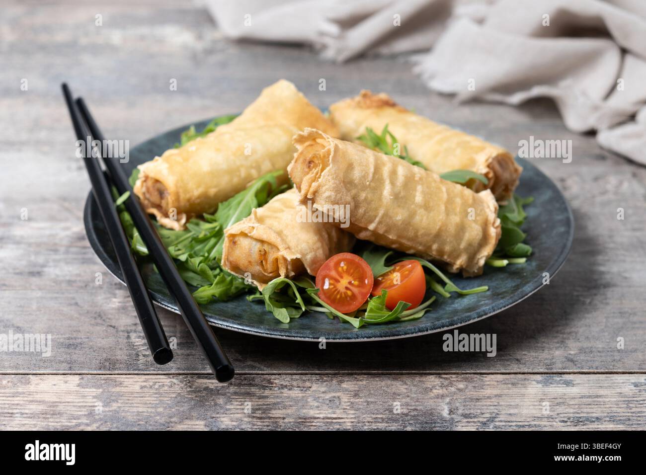 Crispy vegetables spring Rolls on wooden table Stock Photo