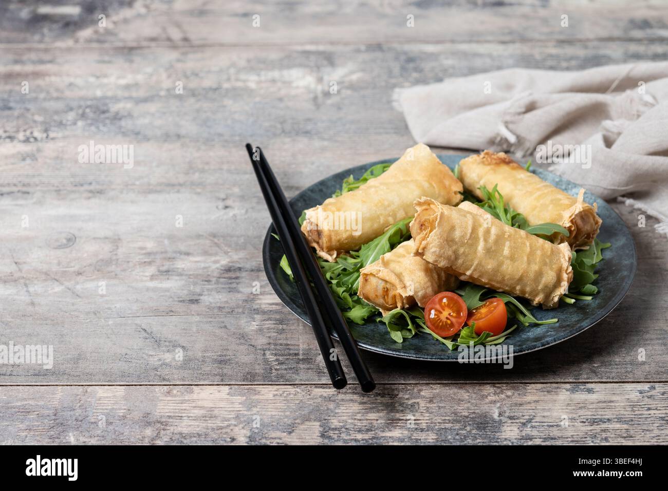 Crispy vegetables spring Rolls on wooden table Stock Photo