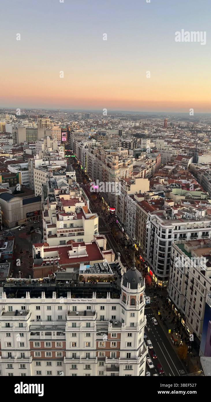 Aerial view of Gran Via and rooftops of central Madrid, Spain, taken during sunset - Smartphone Captured Stock Image