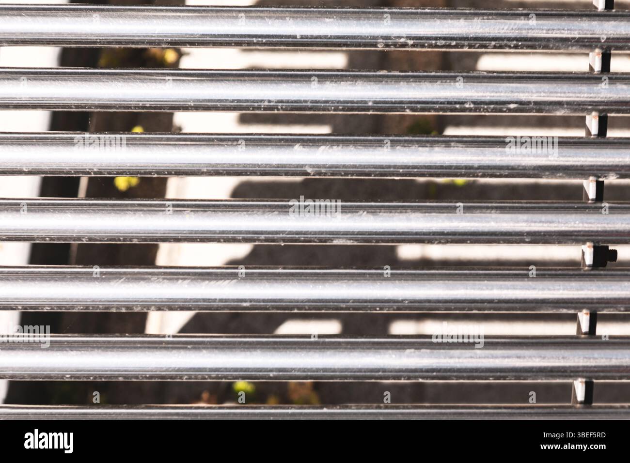 Parallel metal bars, creating a structured and refined design. Detailed ...