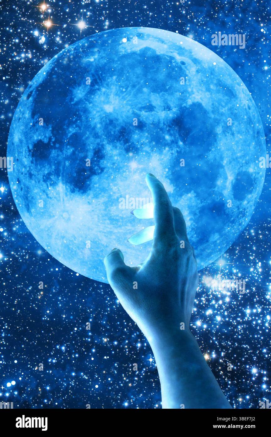 woman hand touching a blue moon Stock Photo