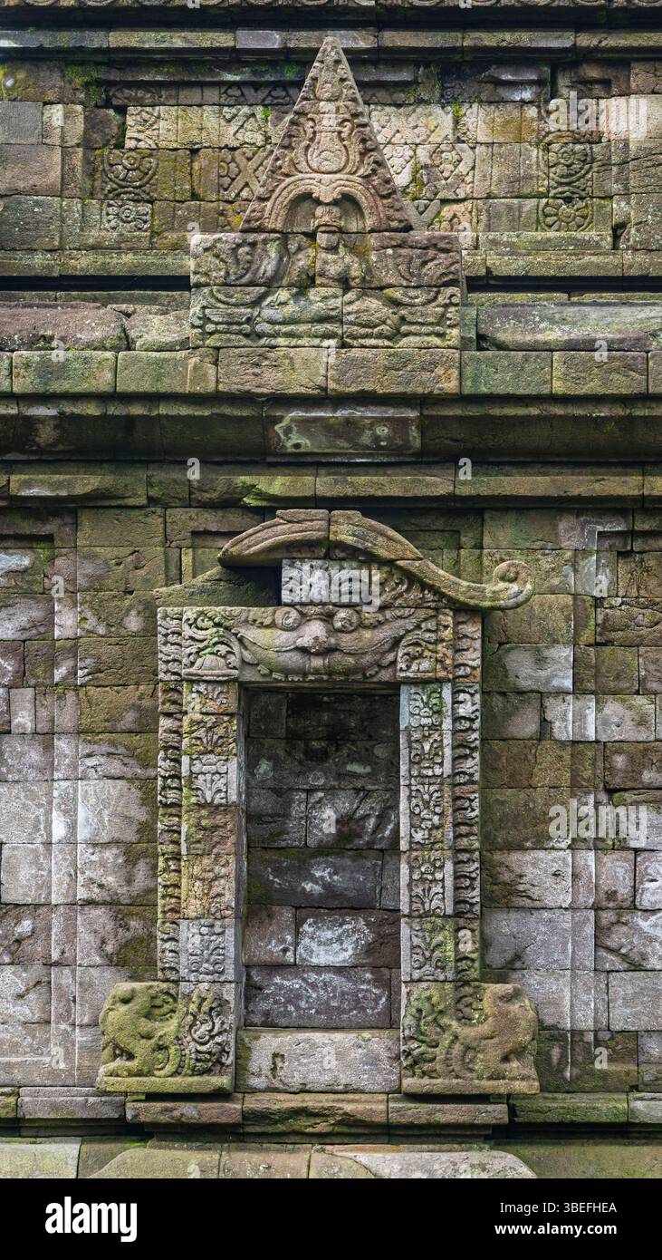 View of exterior wall of ancient hindu Gedong Songo II temple with Kala ...