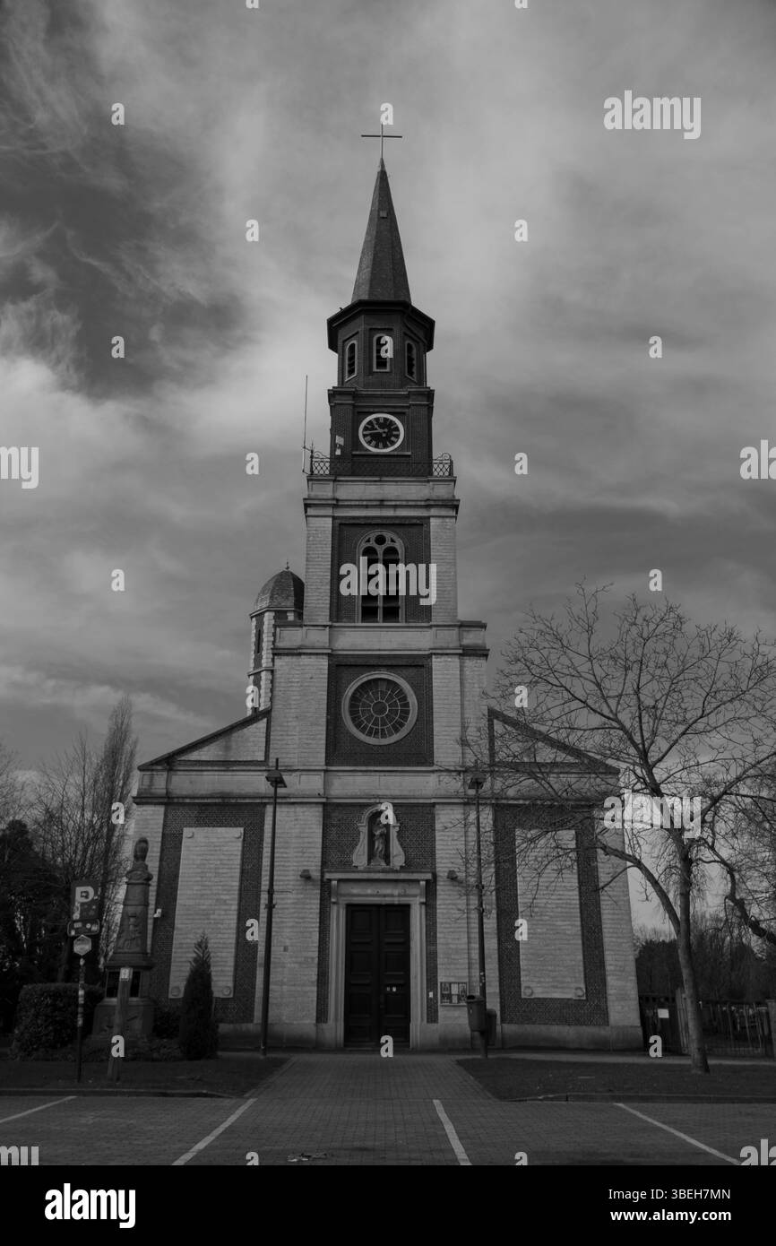 Historic church stands tall against a cloudy sky in a quiet town