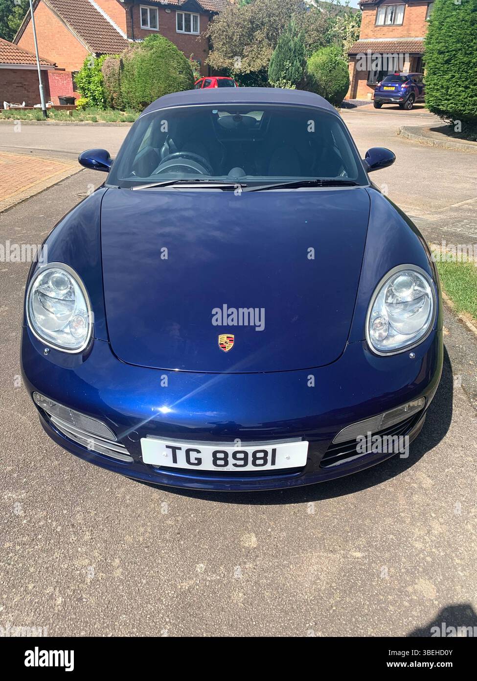 Porsche sports car in blue colour fast speed soft top convertible looks looker posh metallic dream vehicle drive driveway type sporty looker looking - Smartphone Captured Stock Image