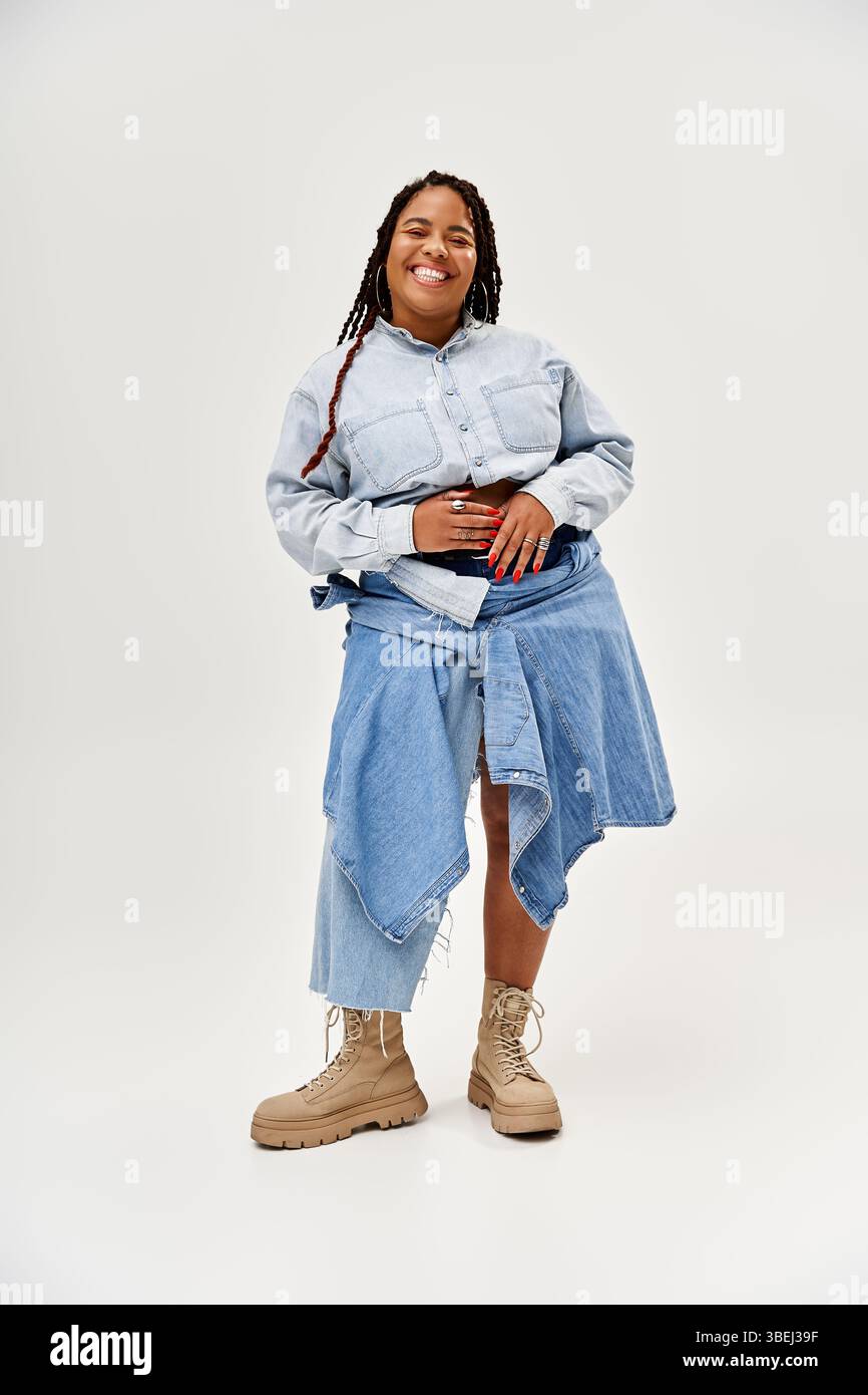 A joyful African American woman with braids showcases her denim ...