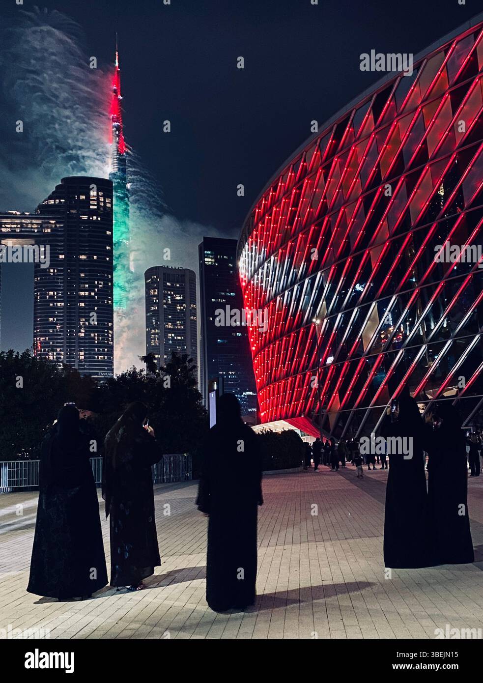 Arab Women enjoying New Years Eve Burj Khalifa Fireworks from Coca Cola arena - Smartphone Captured Stock Image