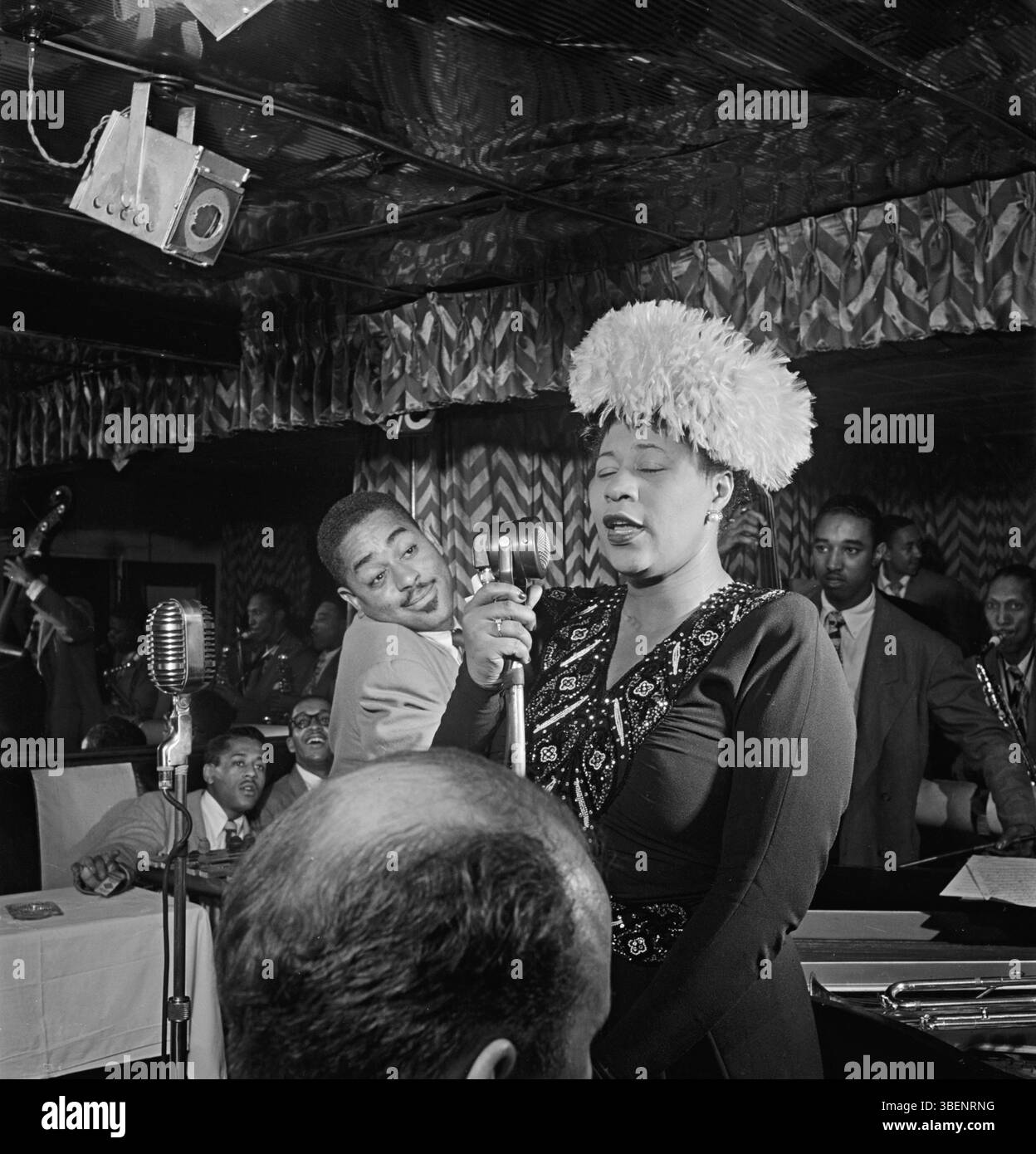 Ella Fitzgerald performing with Dizzy Gillespie, Ray Brown, Milt (Milton) Jackson, and Timmie Rosenkrantz,at the Club Downbeat, New York in Sept. 1947. Ella Jane Fitzgerald (April 25, 1917 – June 15, 1996) was an American singer, songwriter and composer, sometimes referred to as the "First Lady of Song", "Queen of Jazz", and "Lady Ella". She was noted for her purity of tone, impeccable diction, phrasing, timing, intonation, absolute pitch, and a "horn-like" improvisational ability. Stock Photo