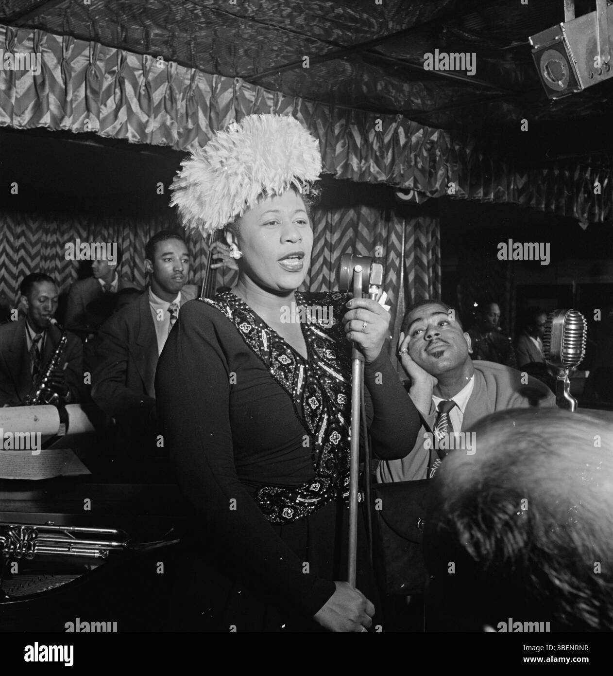 Ella Fitzgerald performing with Dizzy Gillespie, Ray Brown, Milt (Milton) Jackson, and Timmie Rosenkrantz,at the Club Downbeat, New York in Sept. 1947. Ella Jane Fitzgerald (April 25, 1917 – June 15, 1996) was an American singer, songwriter and composer, sometimes referred to as the "First Lady of Song", "Queen of Jazz", and "Lady Ella". She was noted for her purity of tone, impeccable diction, phrasing, timing, intonation, absolute pitch, and a "horn-like" improvisational ability. Stock Photo