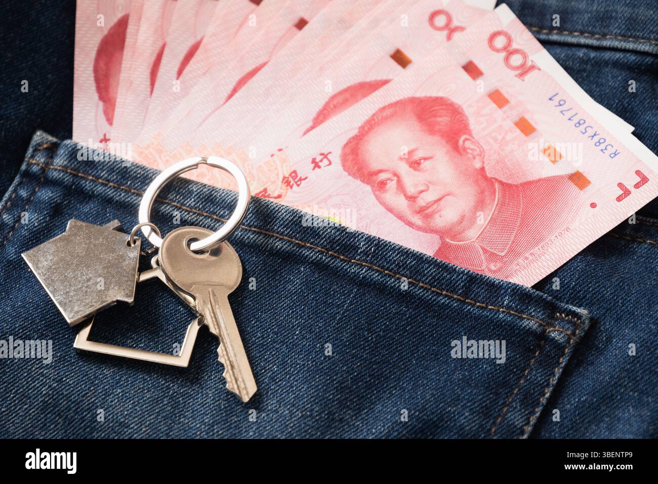 Chinese yuan 100 banknotes and key for house in jeans back pocket ...