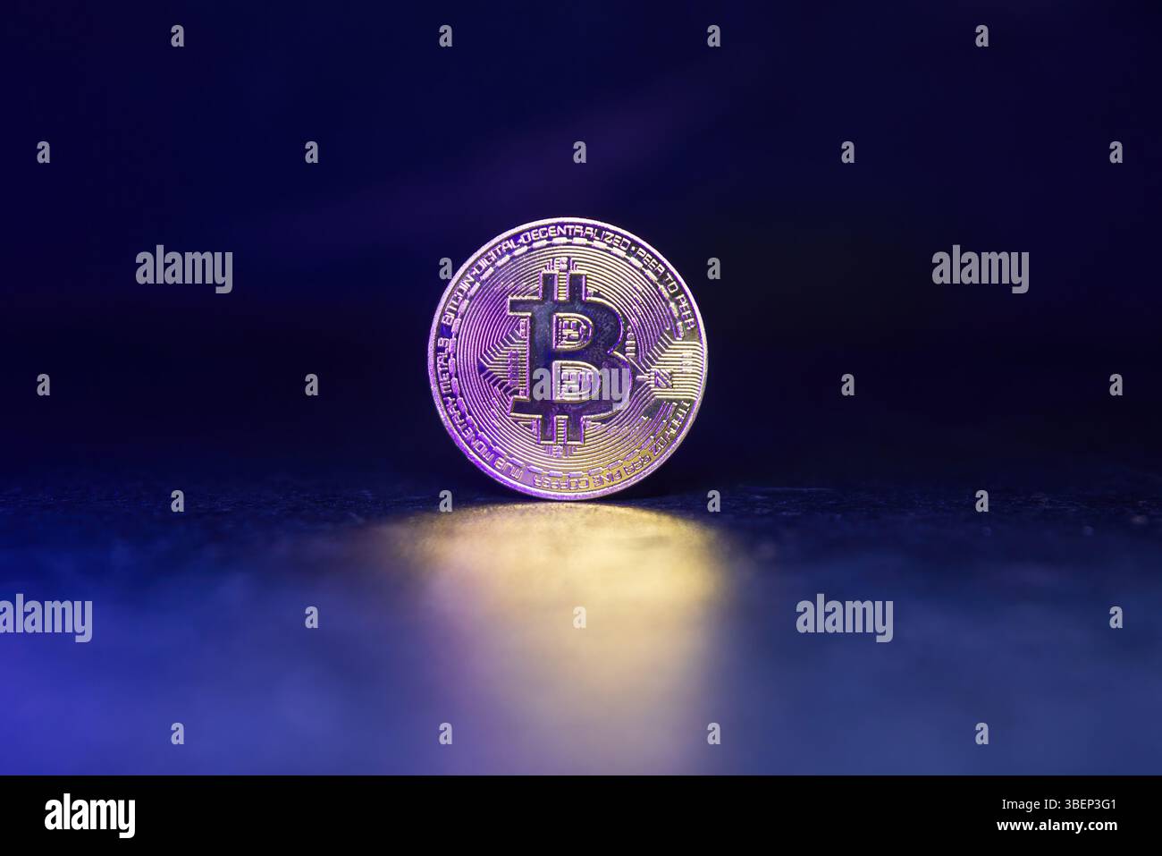 Bitcoin with Golden Glow Reflected on Surface Stock Photo