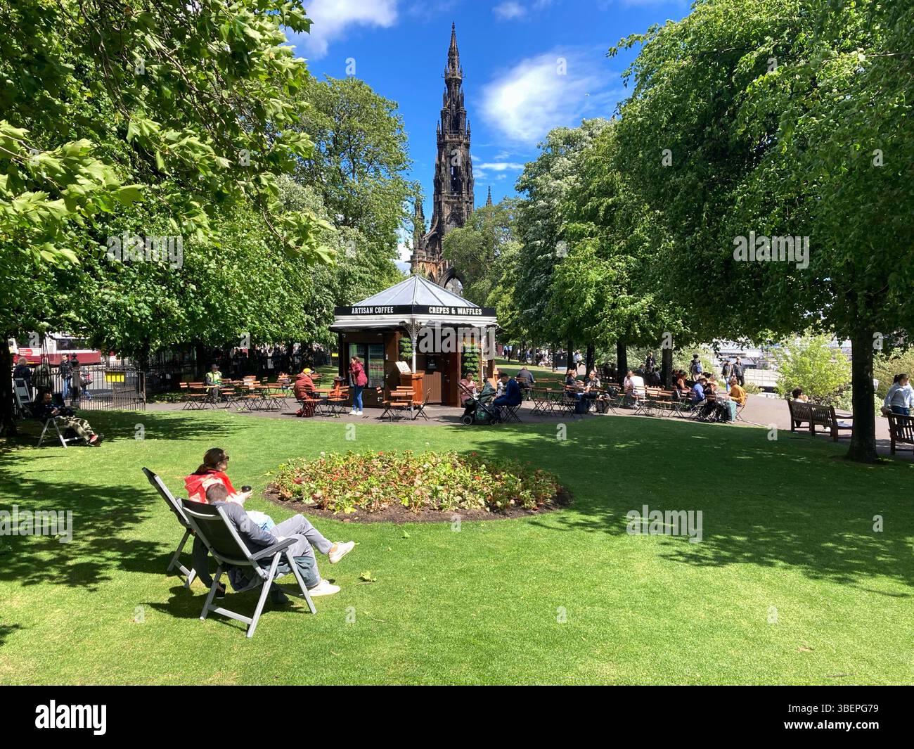 People enjoying Princes Street Gardens and cafe on a warm and sunny Spring day, Edinburgh Scotland - Smartphone Captured Stock Image