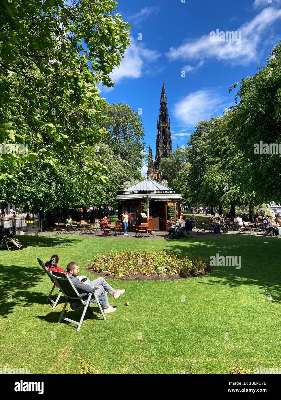 People enjoying Princes Street Gardens and cafe on a warm and sunny Spring day, Edinburgh Scotland - Smartphone Captured Stock Image