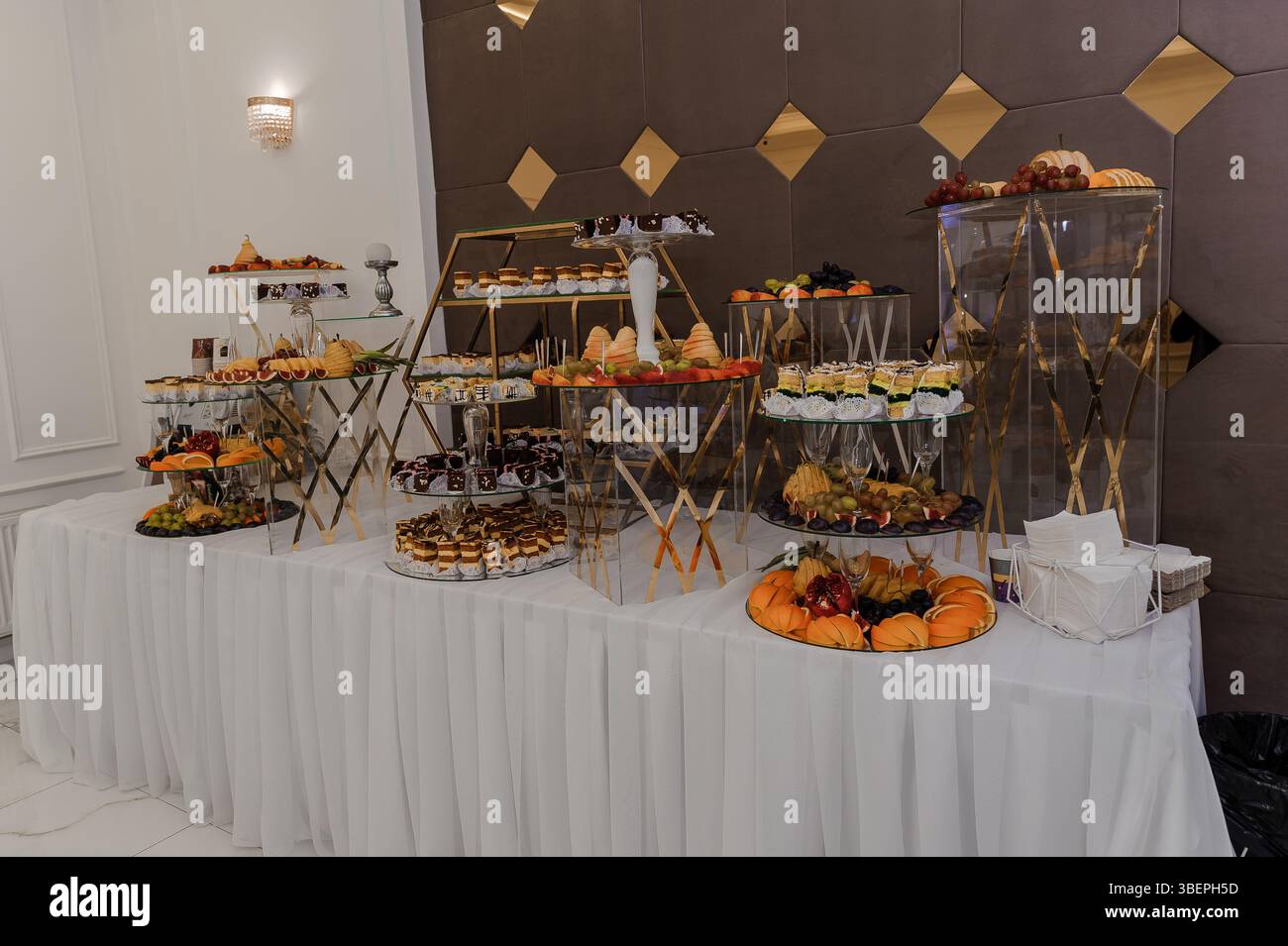 Elegant dessert buffet display at a special event featuring tiered ...