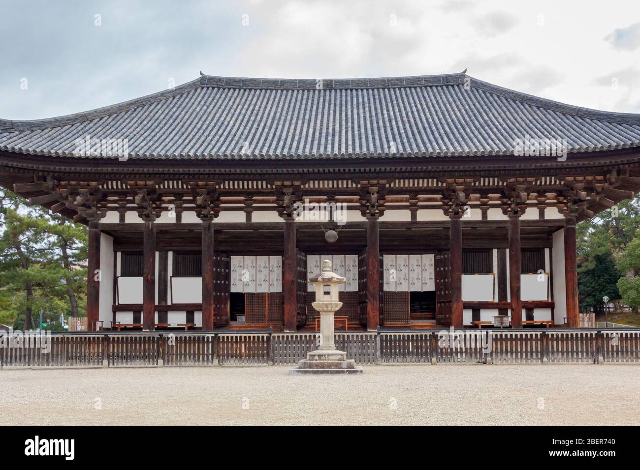 Giant wooden Japanese traditional style temple building located at the Kofuku-Ji buddhist temple in Nara Japan. Photo taken on a cloudy day. Stock Photo