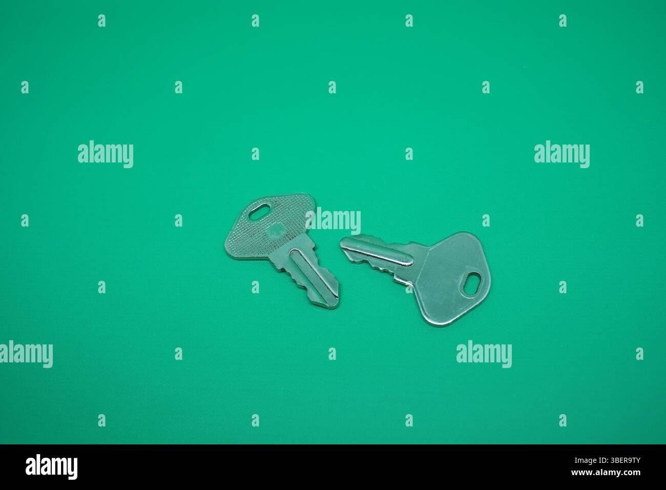 Two pair stainless lock isolated on green. Stock Photo
