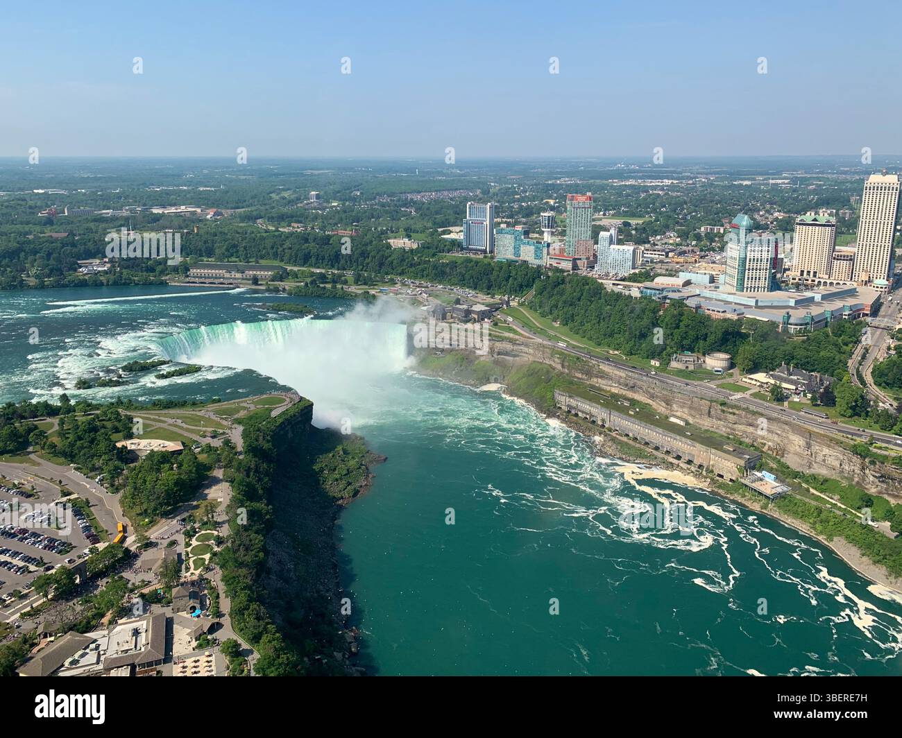 Aerial view of Horseshoe Falls and Niagara River with Canadian skyline in Niagara Falls, Ontario, on a clear summer day. - Smartphone Captured Stock Image
