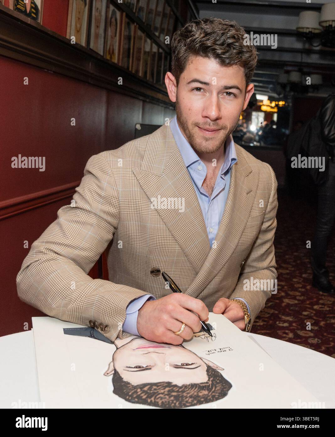 New York, NY, May 29, 2025: Nick Jonas autographs his caricature while ...