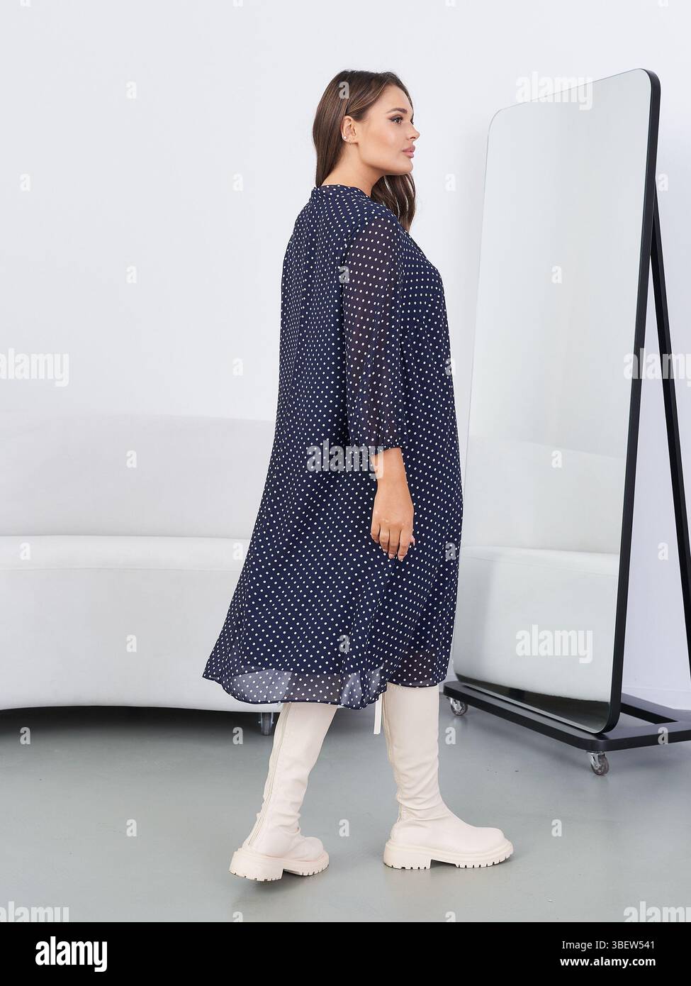 A model wears a brown and white polka dot coat dress during Betsey Johnson's  spring 2006 fashion show at 7th on Sixth Monday, Sept. 12, 2005, in New  York. (AP Photo/Kathy Willens