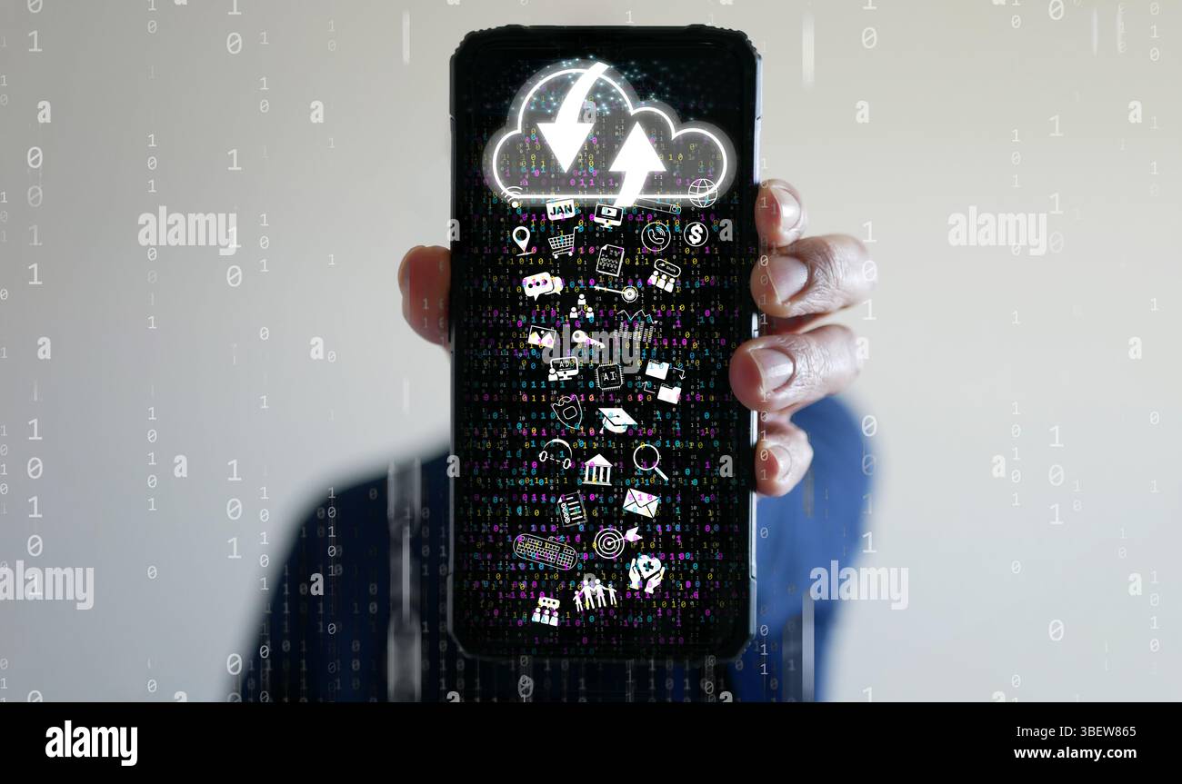 Cloud Computing Concept – A man uses a smartphone to upload and download IT resources via cloud technology, featuring binary code, data streams, netwo Stock Photo