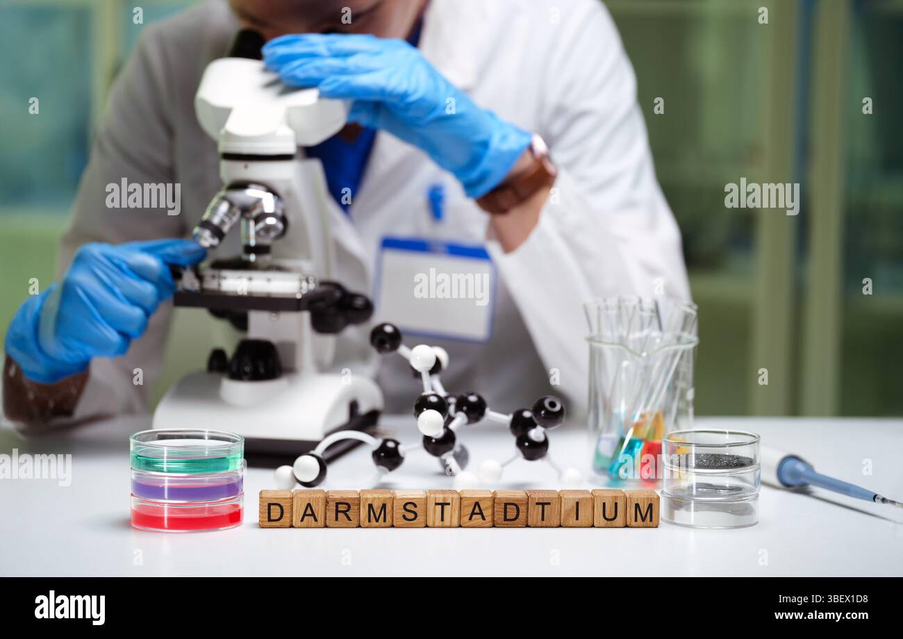 A scientist is meticulously examining various samples under a microscope in a laboratory setting Stock Photo