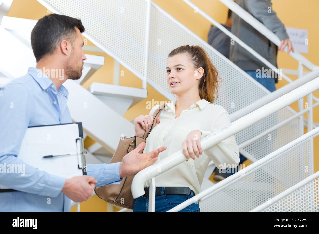 teacher and student walking and talking together Stock Photo - Alamy