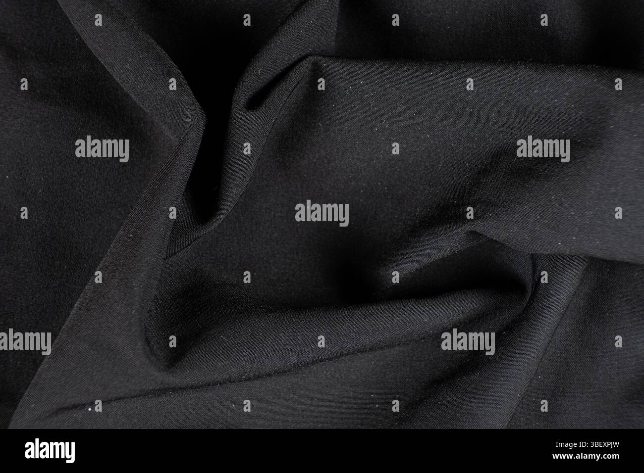 Old worn-out polyester and elastane fabric, pilling and frayed threads. Stock Photo