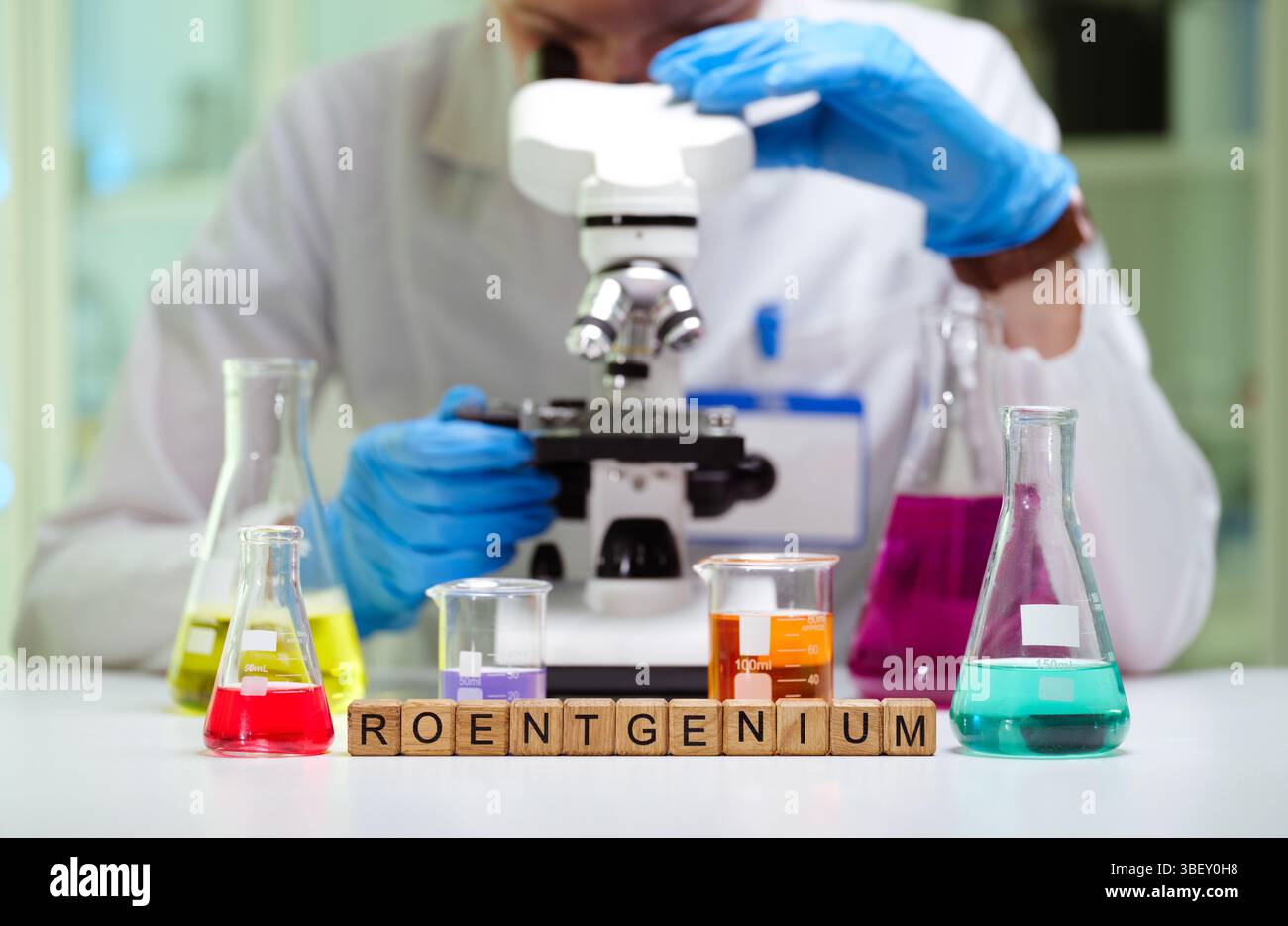 A dedicated scientist is analyzing samples with a microscope in a laboratory for research Stock Photo