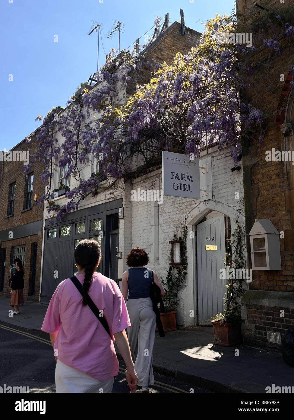 Tourists enjoying an iconic and aesthetic cafe in Notting Hill in London, England, United Kingdom, Europe on a sunny day in Spring. - Smartphone Captured Stock Image