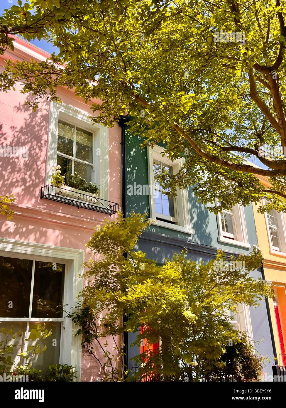 The iconic pastel coloured buildings and aesthetic streets of Notting Hill, London City, England, United Kingdom, Europe on a sunny day in Spring. - Smartphone Captured Stock Image