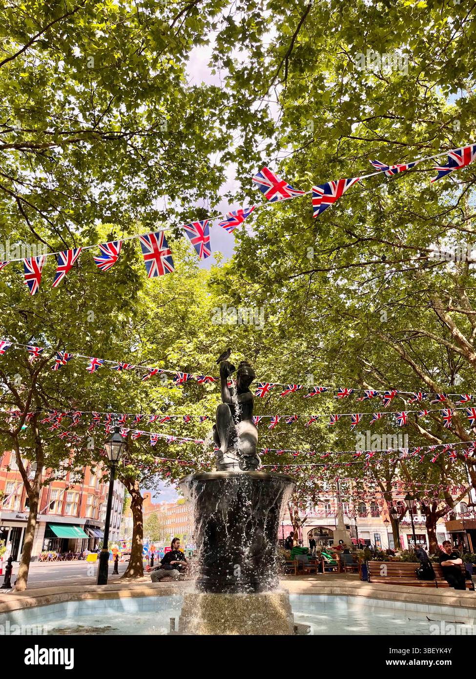A popular park with an aesthetic water fountain in Chelsea, London, England, United Kingdom, Europe on a sunny day in Spring. - Smartphone Captured Stock Image