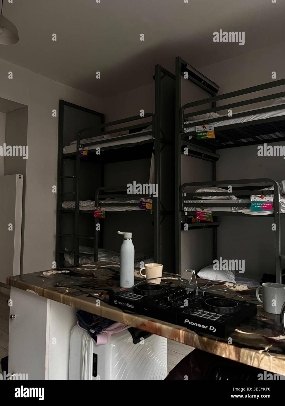 The interior of a classic hostel in London City complete with triple decker bunk beds, and a DJ spin deck in Kensington and Chelsea, London, England. - Smartphone Captured Stock Image