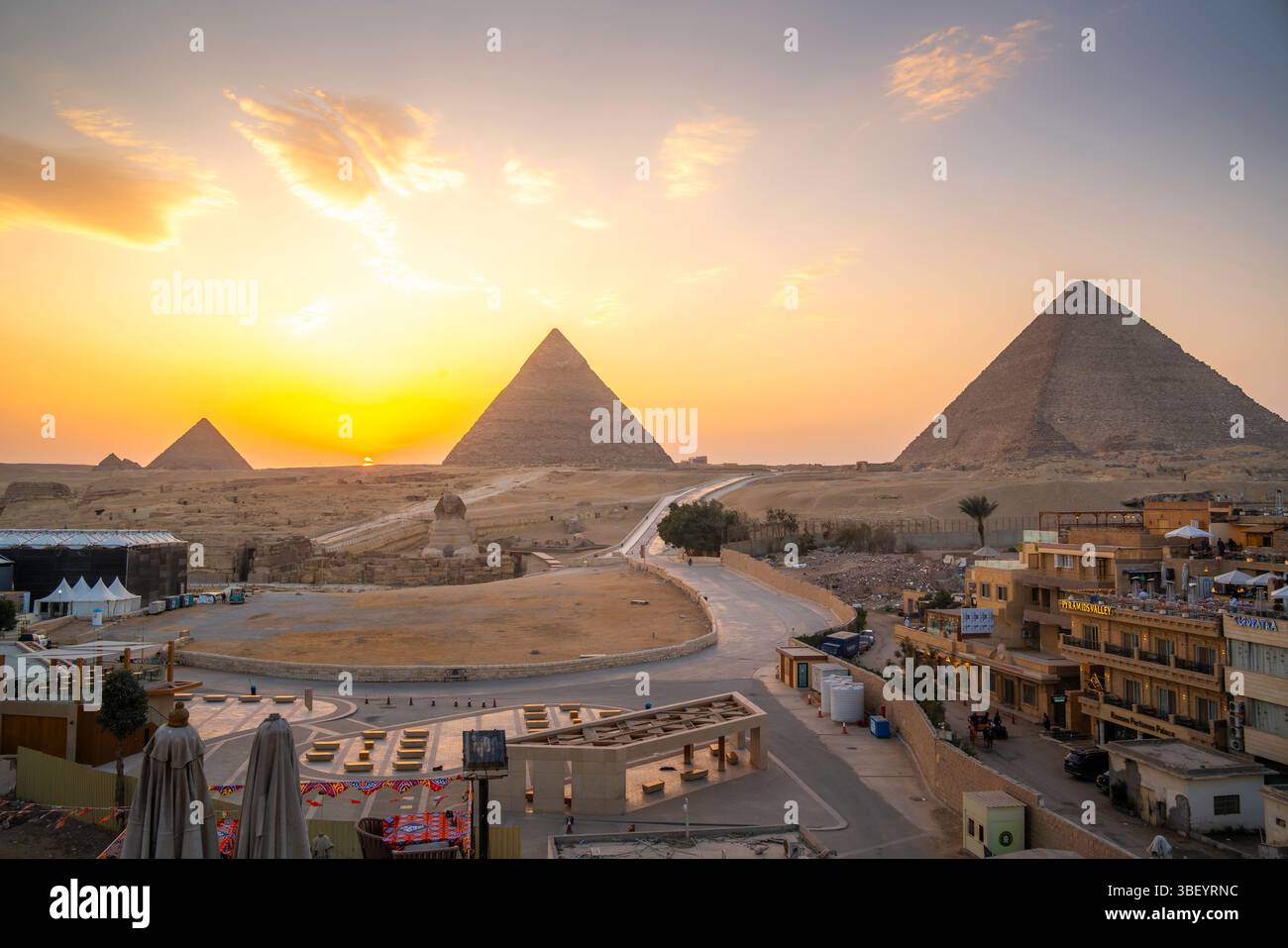 View of Giza Pyramids from rooftop terrace at sunset, Cairo, Egypt ...
