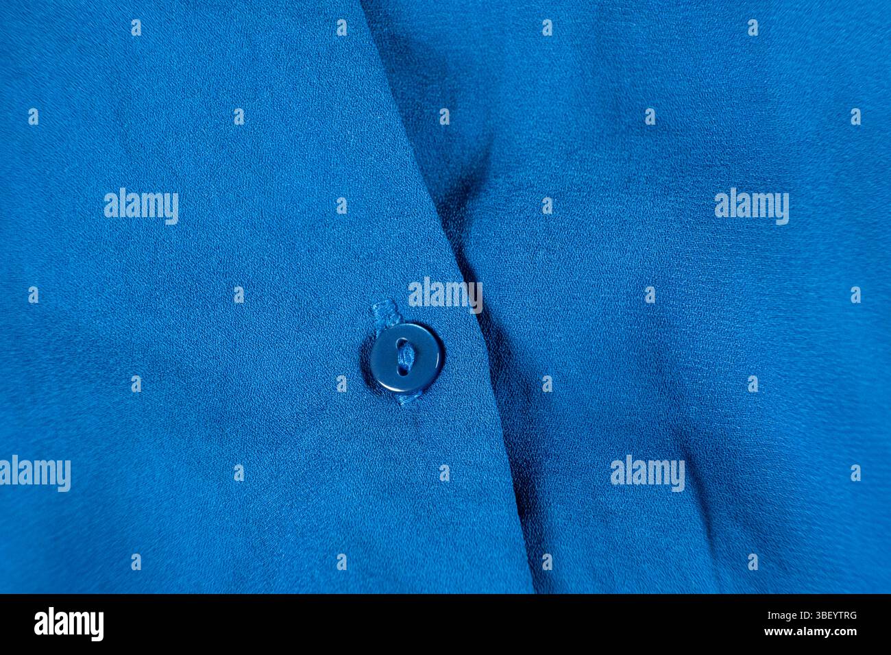 Button on a polyester shirt close-up. Stock Photo