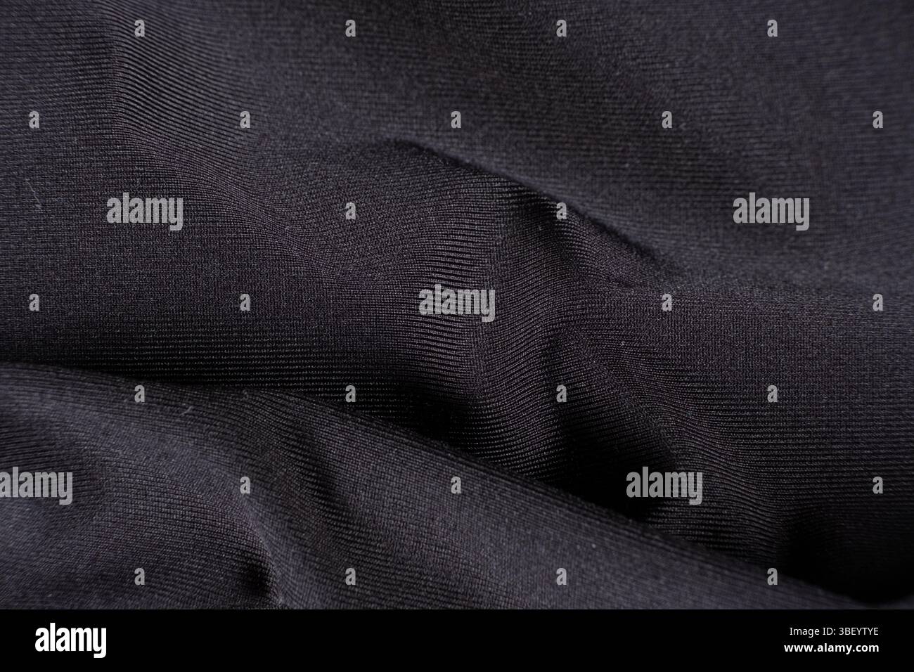Old worn-out polyester and elastane fabric, pilling and frayed threads. Stock Photo