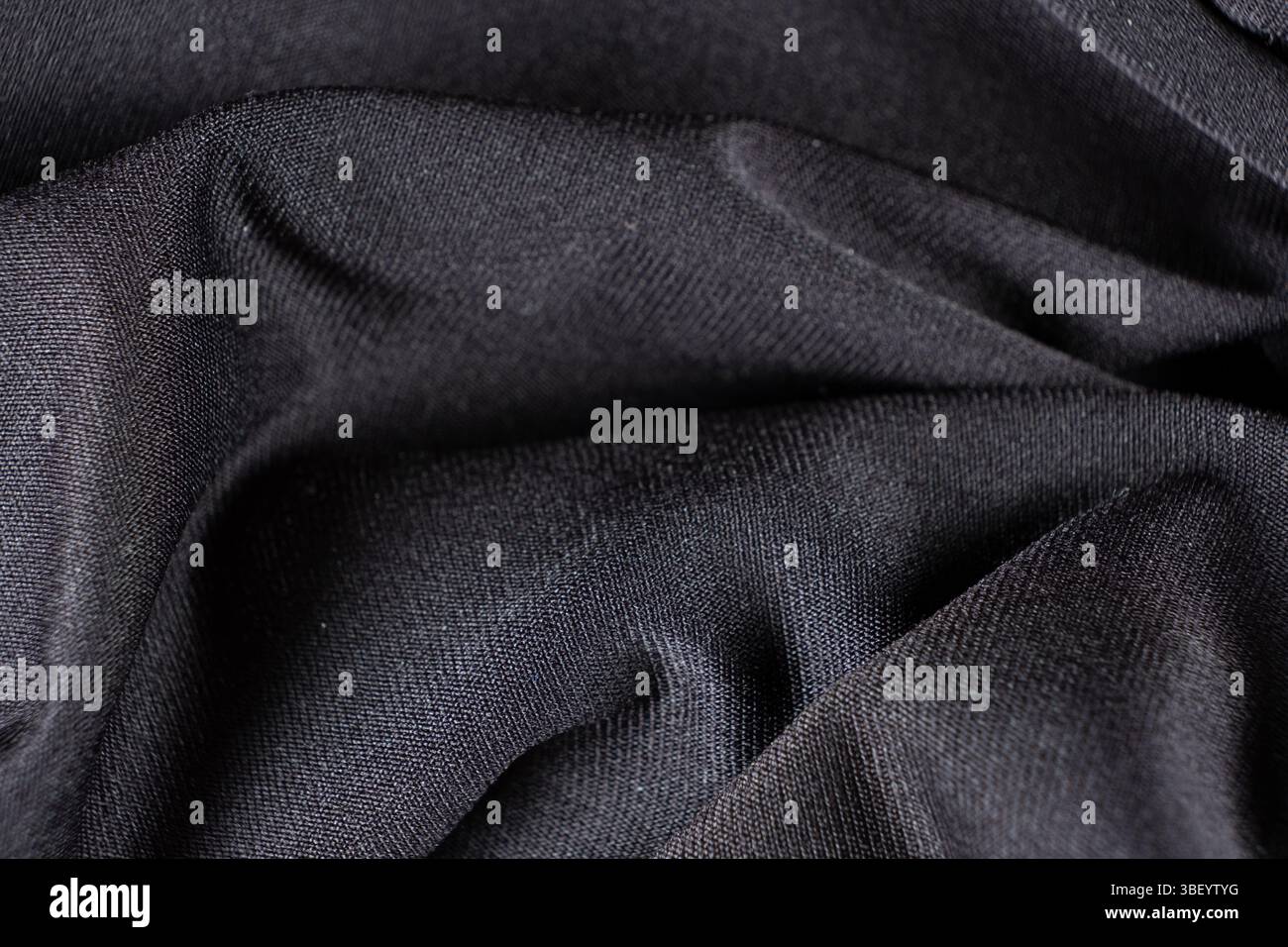 Old worn-out polyester and elastane fabric, pilling and frayed threads. Stock Photo