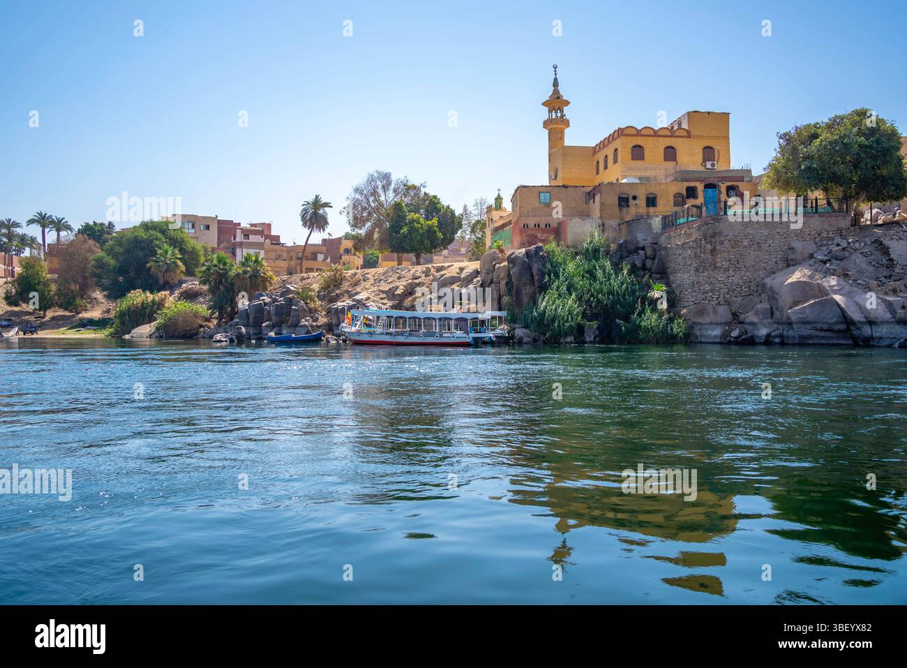 View of architecture on the Nile river from small boat in Aswan, Aswan ...