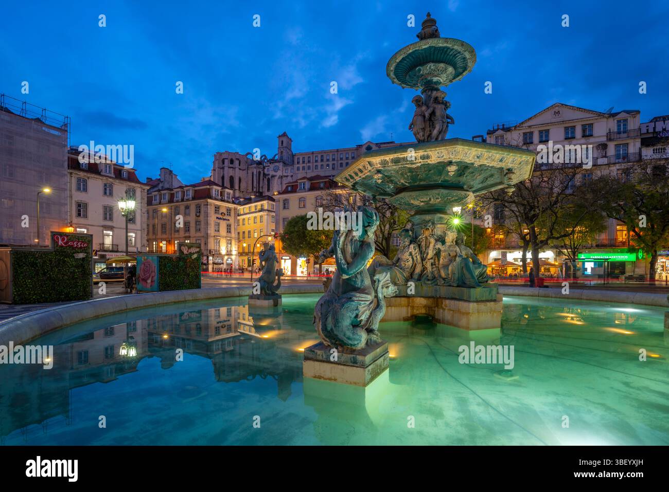View of South fountain of Rossio in Praca do Rossio at dusk, Lisbon, Portugal, Europe Stock Photo