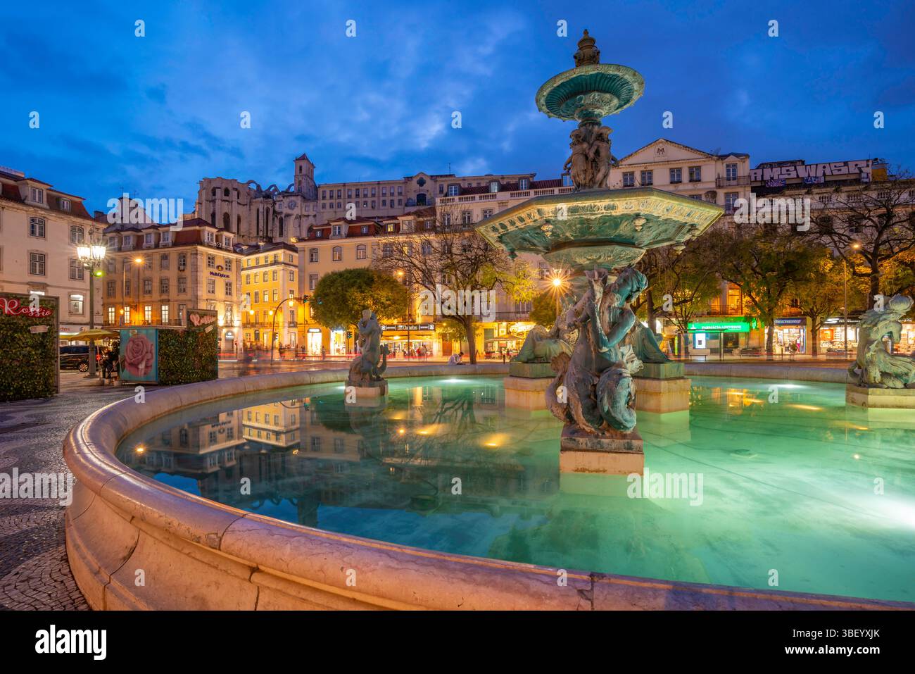 View of South fountain of Rossio in Praca do Rossio at dusk, Lisbon, Portugal, Europe Stock Photo