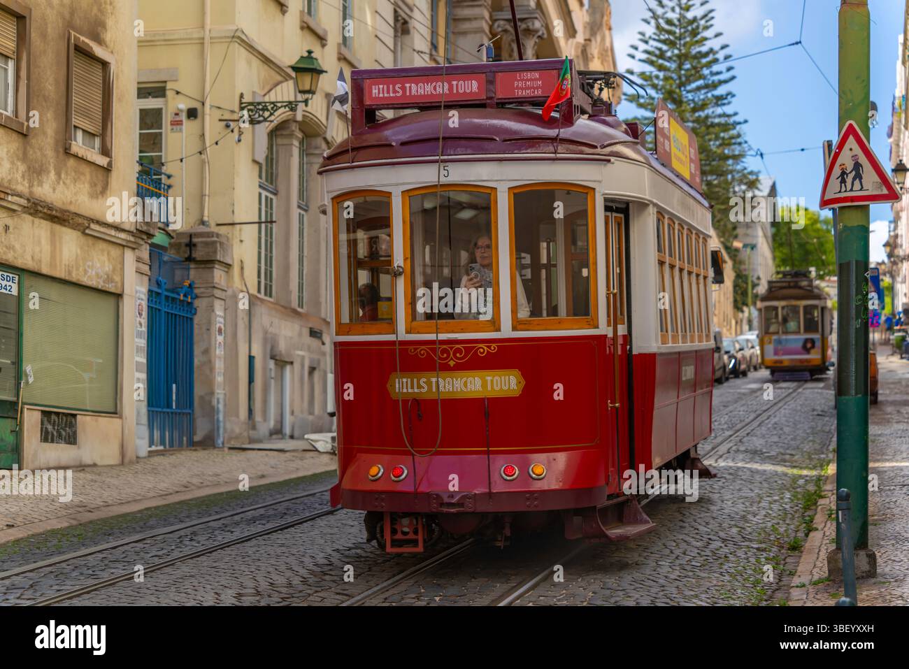 View of vintage red tram on a sunny day in the Alfama District, Lisbon, Portugal, Europe Stock Photo
