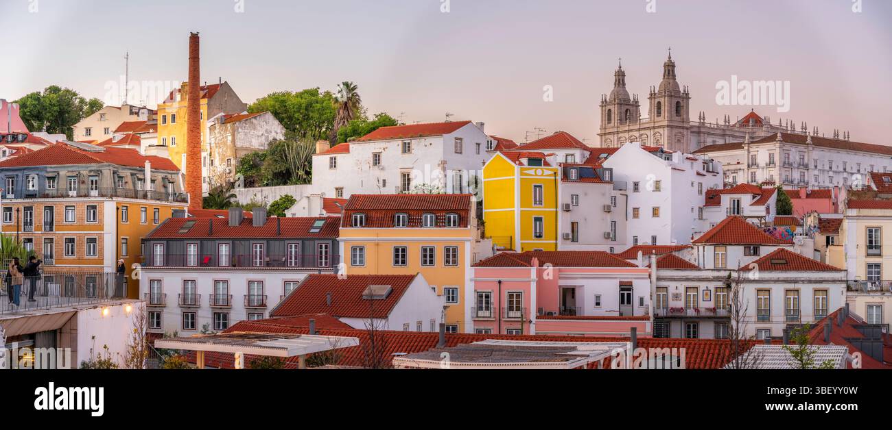 View of colourful buildings and red rooftops at sunset in the Alfama District, Lisbon, Portugal, Europe Stock Photo
